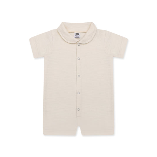 A soft, cream-colored newborn baby romper with a rounded collar, short sleeves, and short legs. The romper features snap buttons down the front for easy dressing. The background includes playful doodles, text highlighting key features like 'Snap Button' and 'Short Sleeves & Legs,' along with 'New Arrivals' branding from Palm and Pale. The tagline at the bottom reads 'Sunny styles for little smiles.'