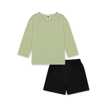 Newborn baby outfit featuring a long-sleeve green shirt with snap buttons on the shoulders and black short boxer. The design is simple and breathable, perfect for little smiles. Background includes playful elements and text highlights like 'New Arrivals' and 'Sunny styles for little smiles.' Brand logo and website 'palmandpale.com' are included.